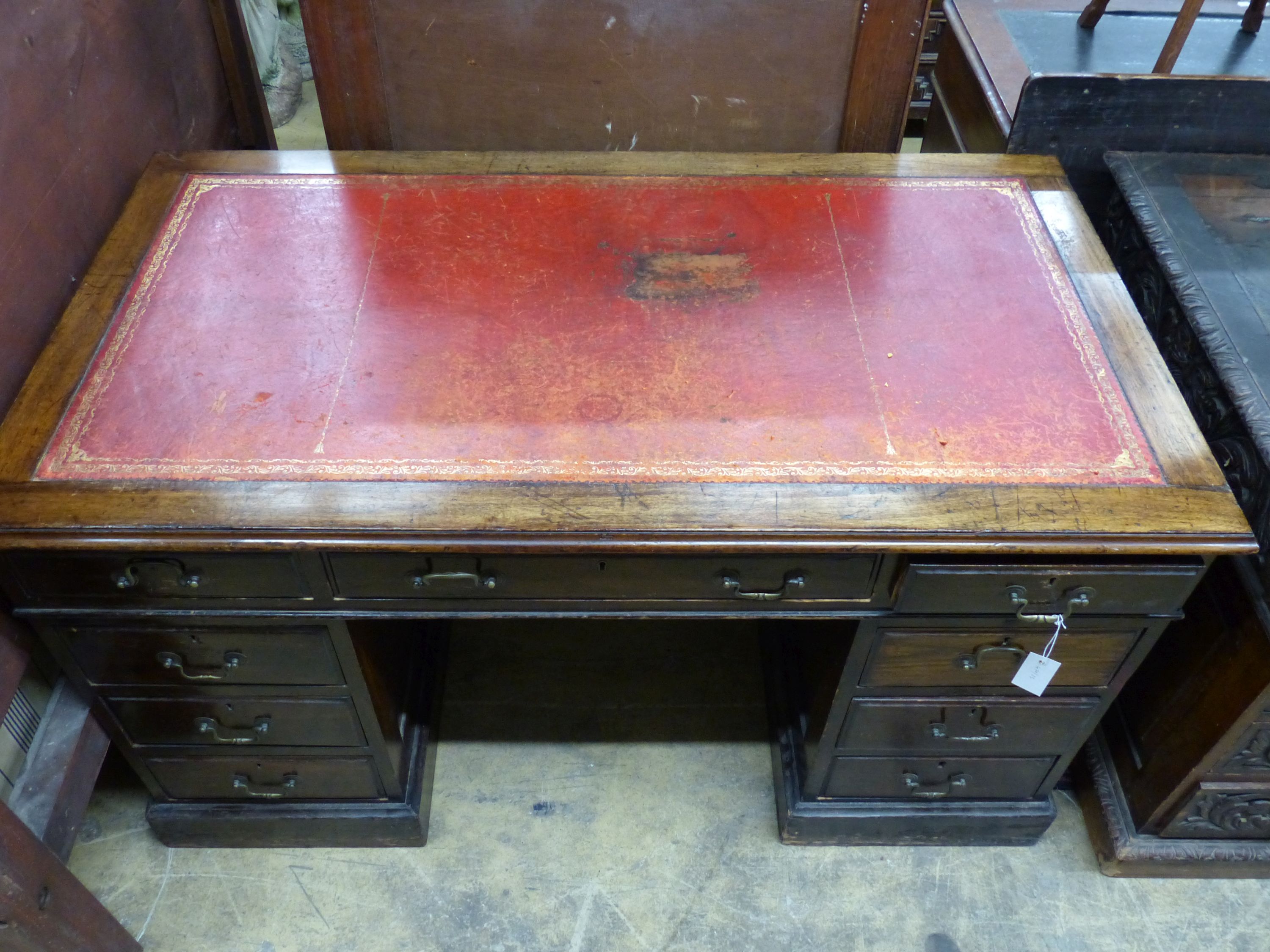 An Edwardian walnut pedestal desk, length 136cm